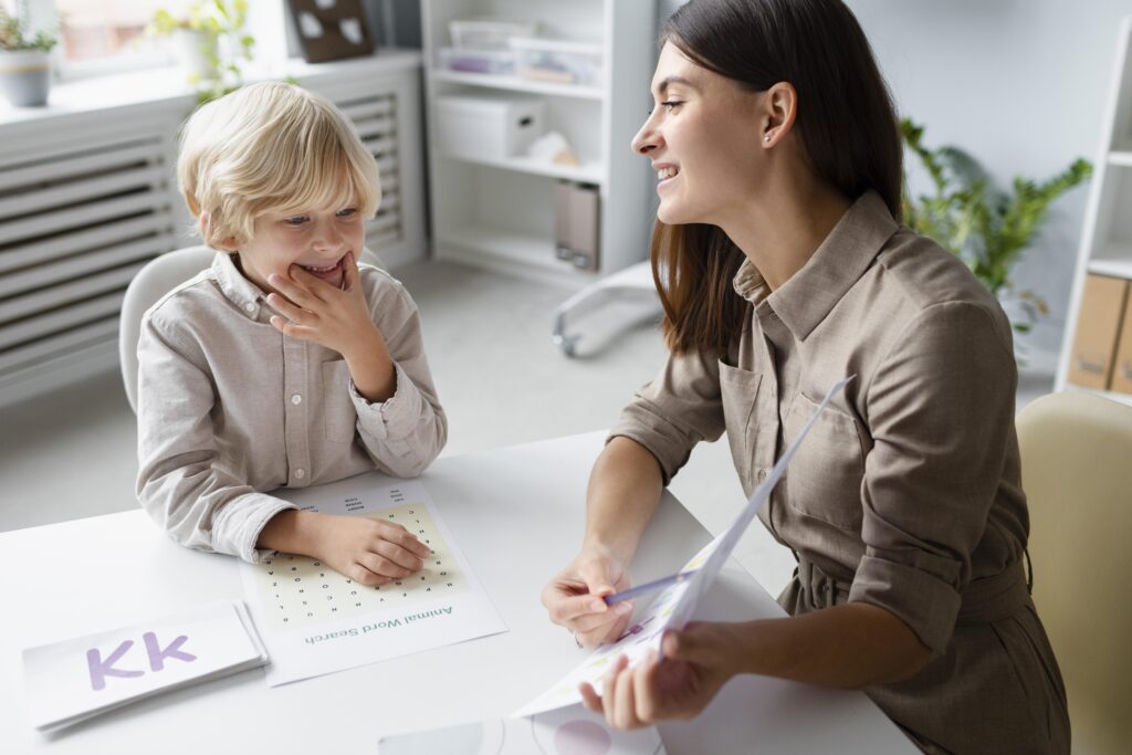 woman doing speech therapy with little blonde boy